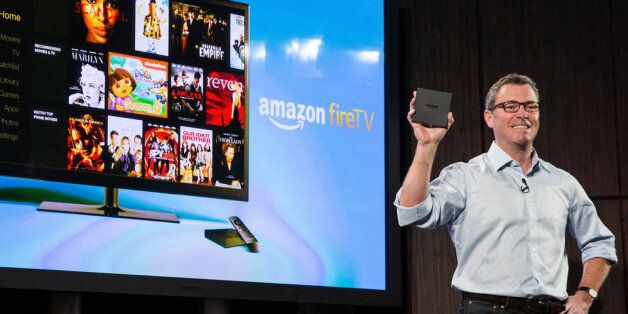 NEW YORK, NY - APRIL 02: (Editors Note: Transmitted with alternate crop) Amazon's vice president of Kindle, Peter Larsen, displays the Amazon Fire TV, a new device that allows users to stream video, music, photos, games and more through their television, on April 2, 2014 in New York City. The unit goes on sale today and costs $99. (Photo by Andrew Burton/Getty Images)