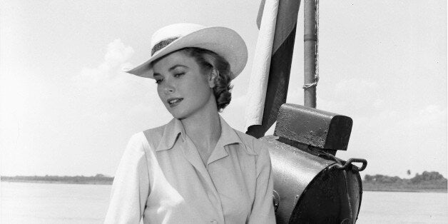 COLUMBIA - 1954: Actress Grace Kelly sits on the rail of a boat on the Magdalena river during filming of the MGM movie 'Gree