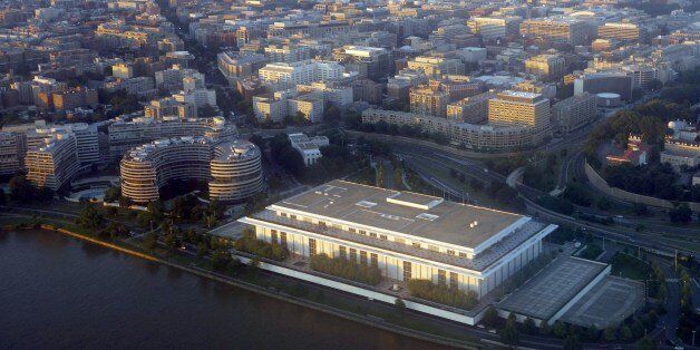 The John F. Kennedy Center for the Performing Arts and the Watergate Complex on the banks of the Potomac River is seen from the air at sunset in this photograph taken on June 15, 2014 over Washington, DC. AFP PHOTO / Saul LOEB (Photo credit should read SAUL LOEB/AFP/Getty Images)