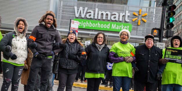 Walmart workers and supporters block Jefferson Street as they protest in front of Walmart Neighborhood Market on Friday, Nov. 28, 2014 in the West Loop in Chicago. The store is one of dozens around the country aimed at focusing attention of paltry wages of retail workers. (Zbigniew Bzdak/Chicago Tribune/TNS via Getty Images)