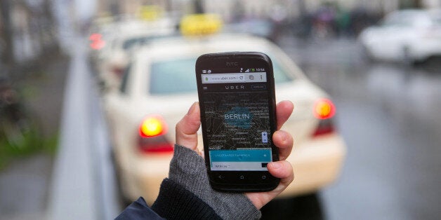 A HTC Corp. smartphone displays a map of Berlin city and surrounding areas on the Uber Technologies Inc. car service application (app) in this arranged photograph in Berlin, Germany, on Monday, Nov. 24, 2014. Uber is reducing the number of vehicles operating in two German cities during non-peak hours as the car-sharing service struggles with legal challenges that have forced it to lower prices. Photographer: Krisztian Bocsi/Bloomberg via Getty Images