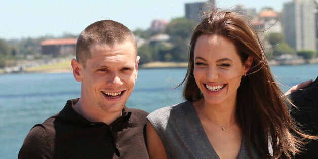 CORRECTS SPELLING OF O'CONNELL - Angelina Jolie, who directed and produced the film "Unbroken," poses for a photo with actor Jack OâConnell after a press conference following the movieâs world premiere in Sydney, Australia, Tuesday, Nov. 18, 2014. (AP Photo/Rob Griffith)