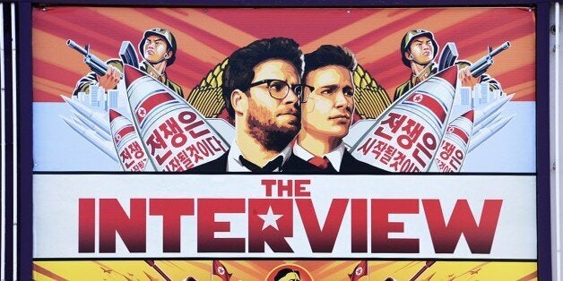 A poster for 'The Interview' is displayed on the marquee of the Los Feliz 3 cinema December 25, 2014 in Los Angeles, California. Some two hundred US theaters are screening the Sony Pictures film starting Christmas Day, notwithstanding threats of terrorism and murmurings of an international cyberwar spawned by the farcical comedy about a plot to assassinate the leader of North Korea before it was even released. AFP PHOTO / ROBYN BECK (Photo credit should read ROBYN BECK/AFP/Getty Images)