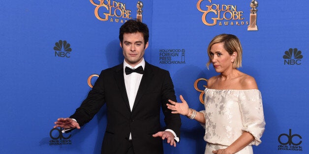 Bill Hader, left, and Kristen Wiig pose in the press room at the 72nd annual Golden Globe Awards at the Beverly Hilton Hotel