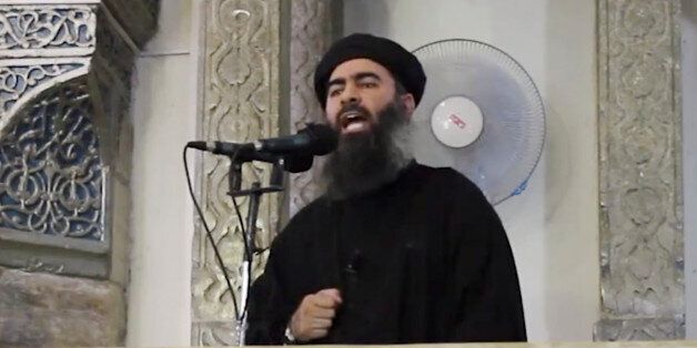 FILE - This file image made from video posted on a militant website Saturday, July 5, 2014, which has been authenticated based on its contents and other AP reporting, purports to show the leader of the Islamic State group, Abu Bakr al-Baghdadi, delivering a sermon at a mosque in Iraq. On Sunday, Nov. 9, 2014, Iraqi officials and state television said al-Baghdadi has been wounded in an airstrike in western Iraq. An Interior Ministry intelligence official told The Associated Press on Sunday that the strike happened early Saturday in the town of Qaim in Iraq's Anbar province. (AP Photo/Militant video, File)