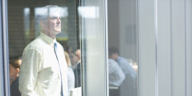 Businessman looking out conference room window