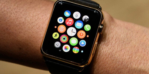 An attendee displays the Apple Watch Edition for a photograph during the Apple Inc. Spring Forward event in San Francisco, California, U.S., on Monday, March 9, 2015. Apple Inc. began showing off features and applications for its first new device in five years, a smartwatch designed to put information on peoples' wrists and break open the fledgling market for wearable technology. Photographer: David Paul Morris/Bloomberg via Getty Images