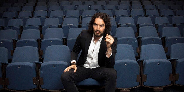 LONDON, ENGLAND - NOVEMBER 25: Russell Brand poses for photographs as he arrives to deliver The Reading Agency Lecture at Th