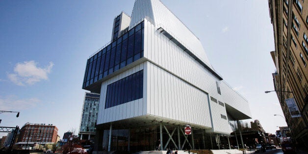 In this Tuesday, April 21, 2015 photo, workers rest on the steps of the Whitney Museum of American Art in New York. The Whitney opens the doors to its new home on May 1. The $422 million Renzo Piano-design is a game-changer for the museum. The 220,000-square-foot space, including 18,000 feet unencumbered by structural columns and 13,000 feet of outdoor terrace galleries, doubles its former home on the Upper East Side. (AP Photo/Mark Lennihan)