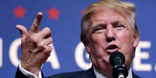 Republican presidential candidate Donald Trump gestures during a campaign stop at Winnacunnet High School in Hampton, N.H., Friday, Aug. 14, 2015. (AP Photo/Charles Krupa)