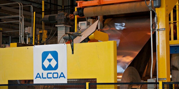 Rolled aluminum is fed into a machine on the auto treatment line at the Alcoa Inc. Davenport Works aluminum facility in River
