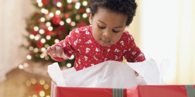 African toddler opening Christmas gift