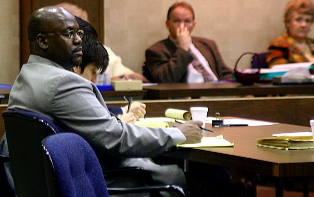 Curtis Flowers (left) listens to testimony in his third capital murder trial in Winona, Mississippi,...