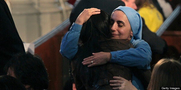 BOSTON - APRIL 18: People embrace in the Cathedral of the Holy Cross before President Barack Obama leads a special interfaith service this morning in memory of the victims of the bombing at the 117th Boston Marathon. (Photo by Bill Greene/The Boston Globe via Getty Images)