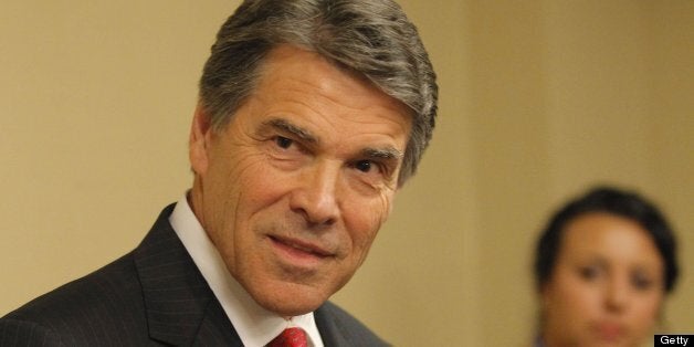 Gov. Rick Perry talks with reporters after speaking to the general session of the 43rd annual National Right to Life Conventi