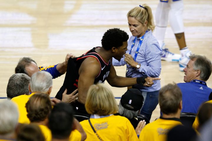 Raptors guard Kyle Lowry points at Warriors minority owner Mark Stevens after the incident.