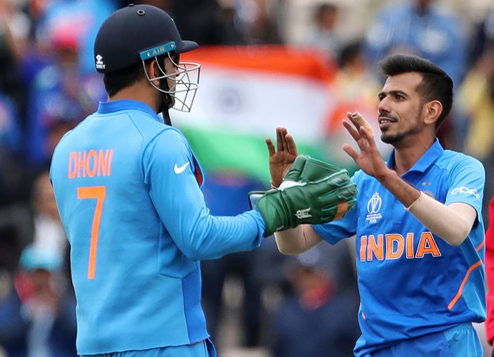 Yuzvendra Chahal, right, celebrates with teammate MS Dhoni the dismissal of South Africa's Andile Phehlukwayo during the Cricket World Cup match between South Africa and India on 5 June 2019.