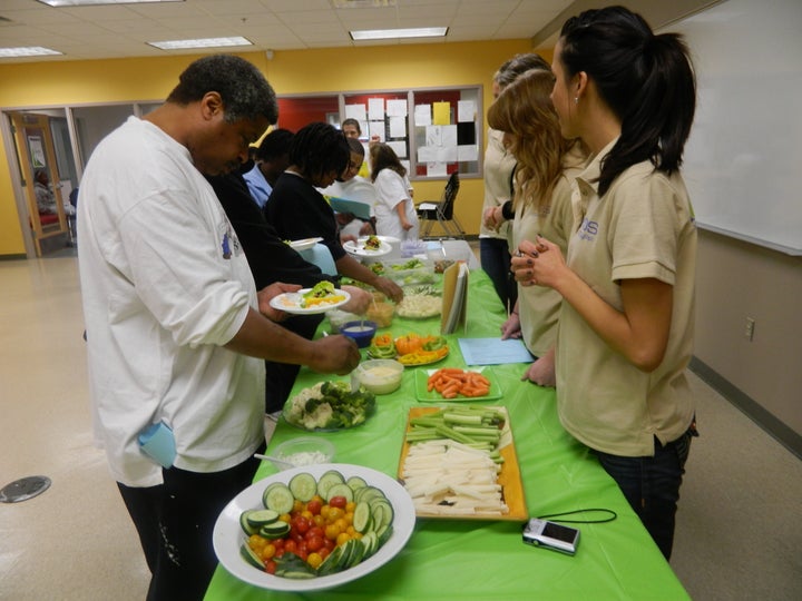 YFDS coaches teach members how to eat and budget for more vegetables in their diets.