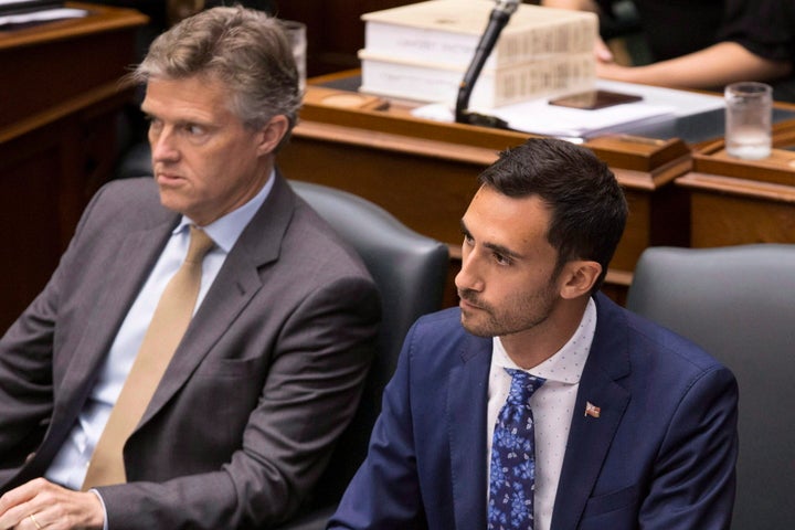 PC MPPs Stephen Lecce, right, and Rod Phillips, left, sit in the legislature in Toronto on July 31, 2018.