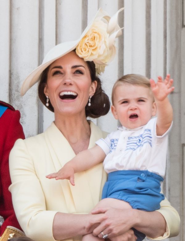 Prince Louis and Catherine, Duchess of Cambridge, appear on the balcony at Buckingham Palace.