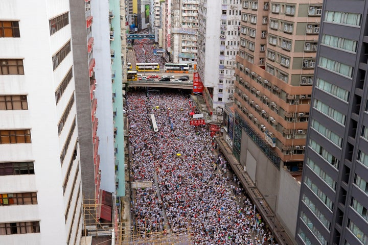 Thousands of protesters march in a rally against the proposed amendments to extradition law in Hong Kong, Sunday, June 9, 201