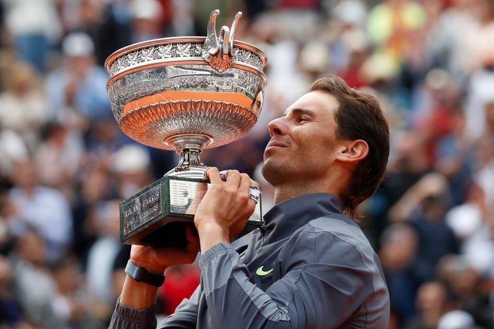 Spain's Rafael Nadal lifts the trophy as he celebrates his record 12th French Open tennis tournament title after winning his men's final match against Austria's Dominic Thiem in four sets, 6-3, 5-7, 6-1, 6-1, at the Roland Garros stadium in Paris, Sunday, June 9, 2019.