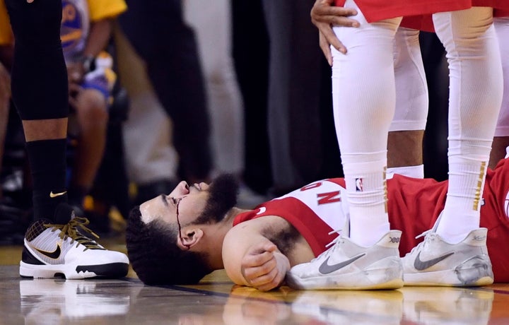 Fred VanVleet lays on the floor as blood flows from below his eye during the second half of Game 4 against the Golden State Warriors in Oakland, Calif. on Friday.