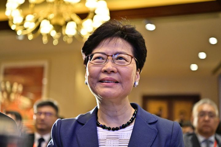 Hong Kong Chief Executive Carrie Lam smiles as she arrives before speaking at the Caixin Summit in Hong Kong on June 10, 2019.