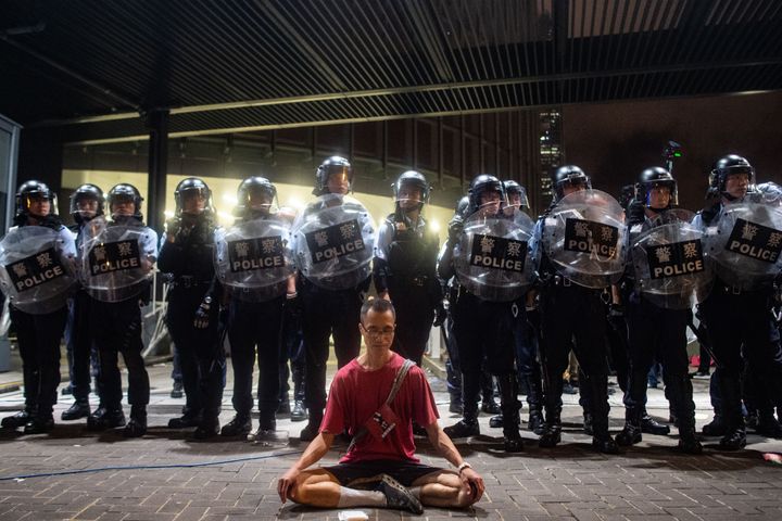 Police gather at a rally against a controversial extradition law proposal in Hong Kong on early June 10, 2019