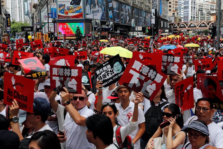 Demonstrators hold yellow umbrellas, the symbol of the Occupy Central movement, and placards during a protest to demand authorities scrap a proposed extradition bill with China, in Hong Kong, China June 9, 2019. 