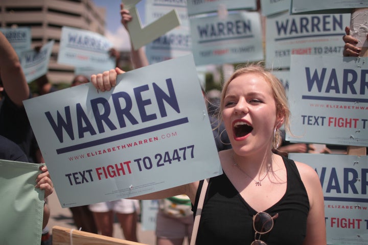 Supporters of Democratic presidential candidate Sen. Elizabeth Warren (D-Mass.) wait for her to arrive at the Iowa Democratic Party's Hall of Fame Dinner on June 9, 2019, in Cedar Rapids, Iowa.