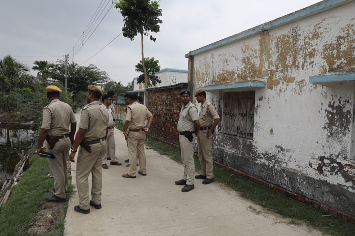 Police stand guard at the scene of the gun battle in Sandeshkhali in West Bengal.