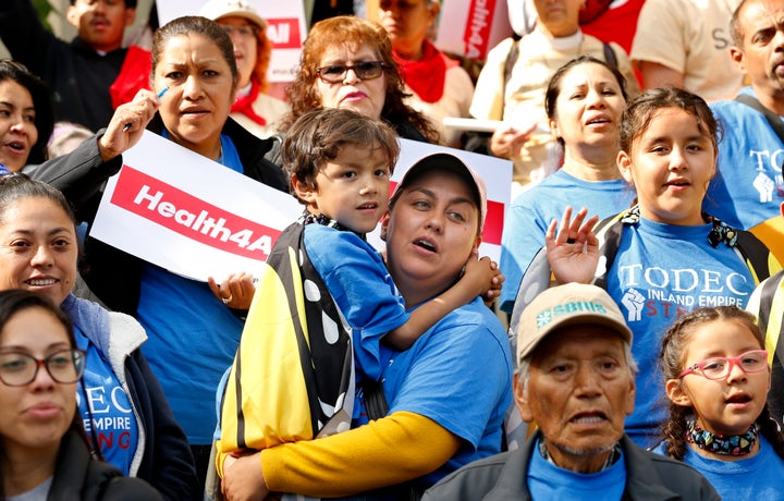 Oralia Sandoval, center, holds her son Benjamin, 6, as she participates in an Immigrants Day of Action rally, Monday, May 20,