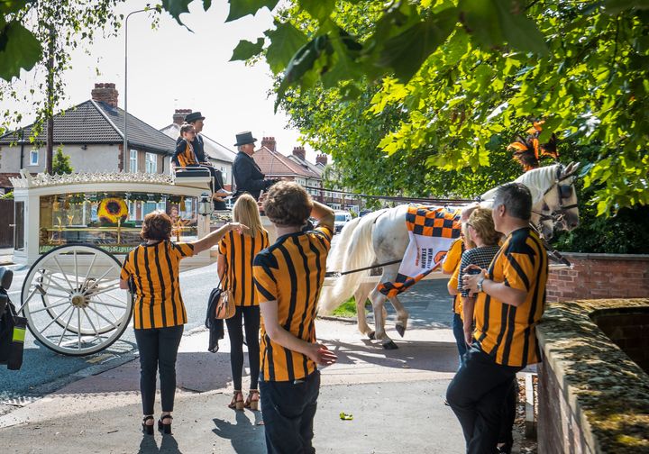 Stanley's twin sister Elsie May sat on top of the horse-drawn hearse carrying his coffin at his funeral last year 