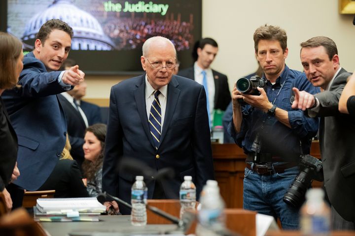 Former White House counsel John Dean is directed to his seat Monday as he arrives for a House Judiciary Committee hearing on the Robert Mueller report.