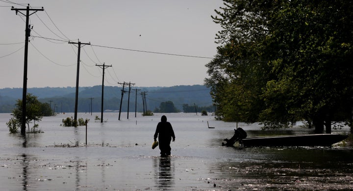 A resident wades through Mississippi River floodwater to his Winfield, Missouri, home on May 24.