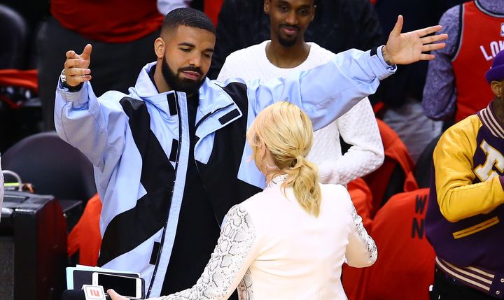 Drake greets TV personality Doris Burke before Game Five of the NBA playoffs. This was taken mere minutes before his emotional singalong to "O Canada."