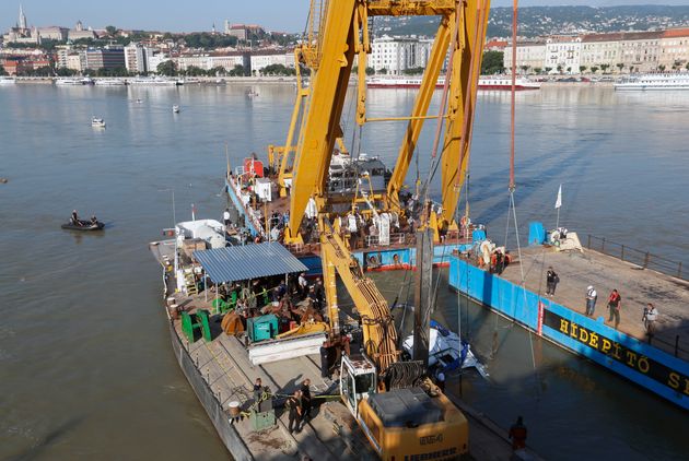 A floating crane is lifting the vessel and will then place it on a long barge, where policy will take over the investigation 