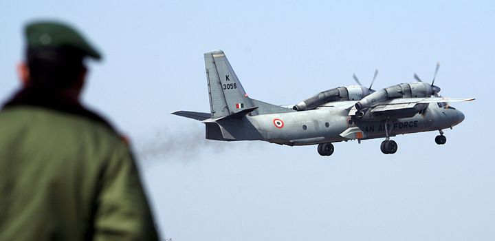 A soldier stands guard as an Indian Air Force AN-32 transport aircraft takes off from the technical airport in Jammu in 2008. 