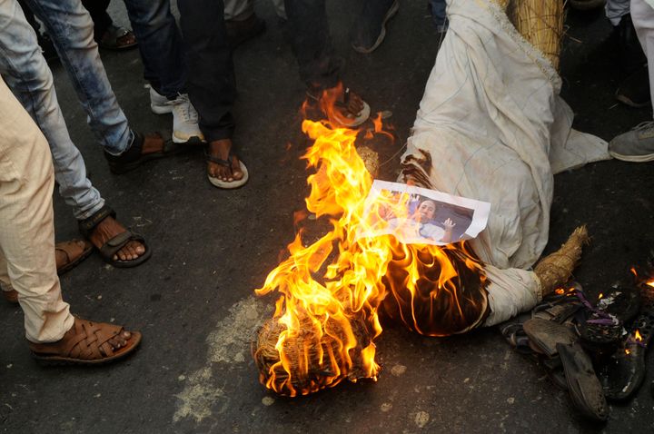 BJP workers burn an effigy of Chief Minister Mamata Banerjee in Kolkata. 