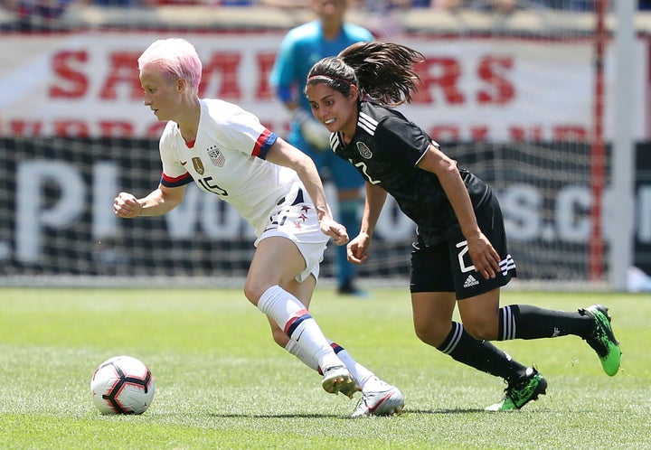 Megan Rapinoe, a forward player on the U.S. women's national team, dribbles the ball away from Mexico defender Kenti Robles in an international friendly soccer match in May. Keep on dribbling to equal pay, sister.