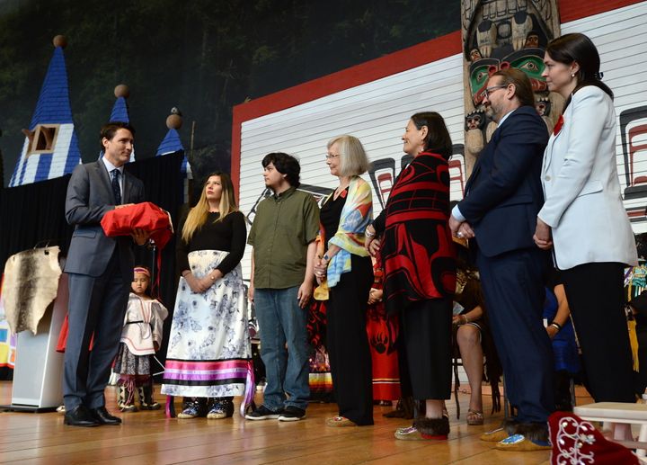 Prime Minister Justin Trudeau holds a copy of the National Inquiry into Missing and Murdered Indigenous Women and Girls final report at a ceremony in Gatineau, Que., on June 3, 2019.