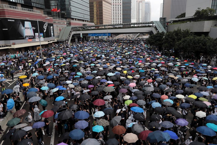 Protestors surrounded government headquarters in Hong Kong on Wednesday as the administration prepared to open debate on a hi