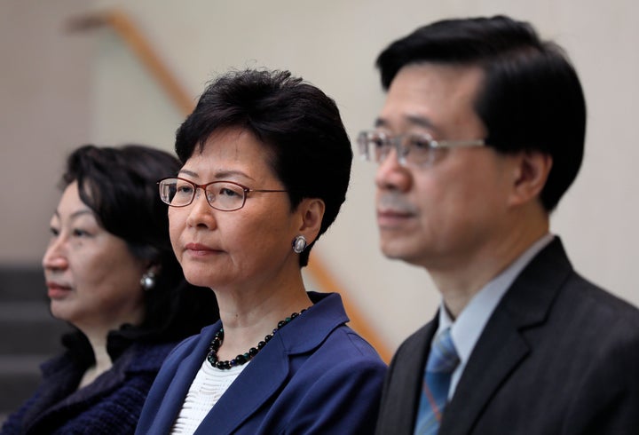 Hong Kong secretary for security John Lee, right, Hong Kong chief executive Carrie Lam, centre, and secretary of justice Teresa Cheng listen to reporters questions during a press conference