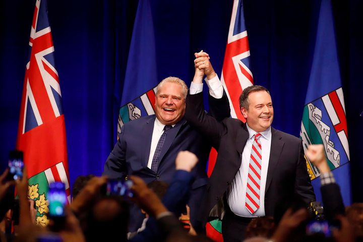 Ontario Premier Doug Ford and Alberta Premier Jason Kenney cheer with supporters at an anti-carbon tax rally in Calgary on Oct. 5, 2018.