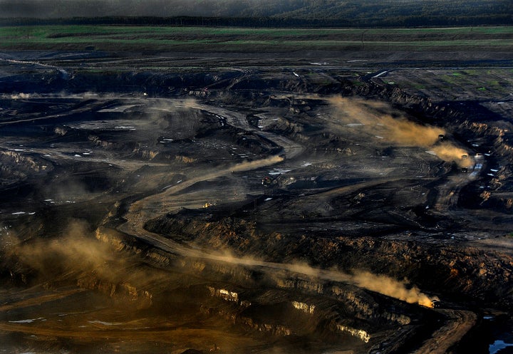 The oilsands open pit mine uses trucks that are 3 stories tall, weigh one million pounds, and cost 7 million dollars each, as shown here near Fort McMurray, Alta., June 20, 2012.