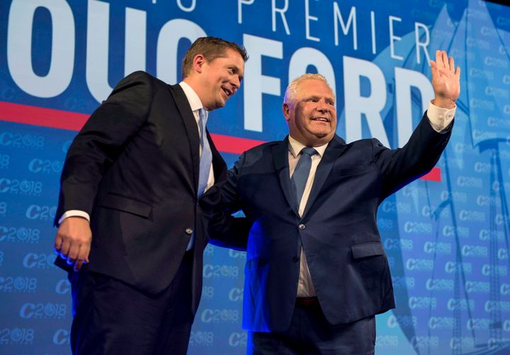 Ontario Premier Doug Ford, right, and Conservative leader Andrew Scheer acknowledge the crowd while on stage at the Conservative national convention in Halifax on Aug. 23, 2018.