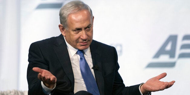 Israeli Prime Minister Benjamin Netanyahu gestures while speaking at the American Enterprise Institute's (AEI) Annual Dinner in Washington, Monday, Nov. 9, 2015. AEI presented Netanyahu with their 2015 Iriving Kristol Award. (AP Photo/Cliff Owen)