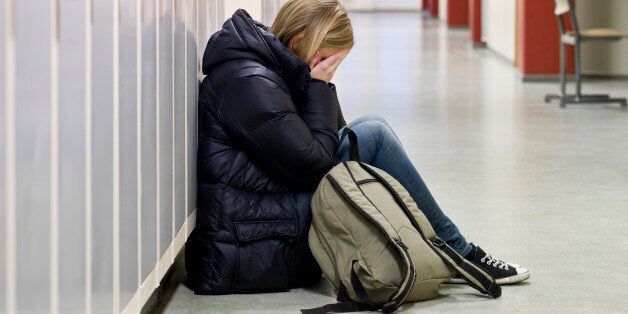 Young woman getting bullied at school