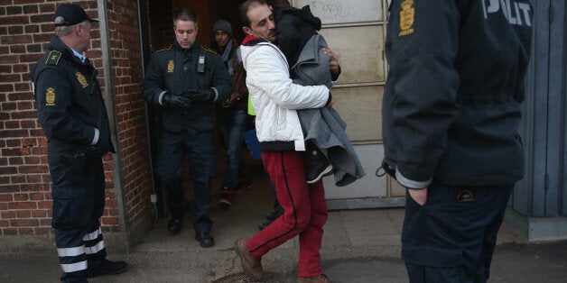 PADBORG, DENMARK - JANUARY 06: Danish police escort a family from Syria seeking asylum in Denmark after finding them while checking the identity papers of passengers on a train arriving from Germany on January 6, 2016 in Padborg, Denmark. Denmark introduced a 10-day period of passport controls and spot checks on Monday on its border to Germany in an effort to stem the arrival of refugees and migrants seeking to pass through Denmark on their way to Sweden. Denmark reacted to border controls intr